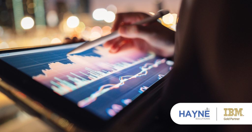 Main: A person adjusts their analytics on a digital screen. Inset: HAYNE Solutions and IBM Gold Partner logos.