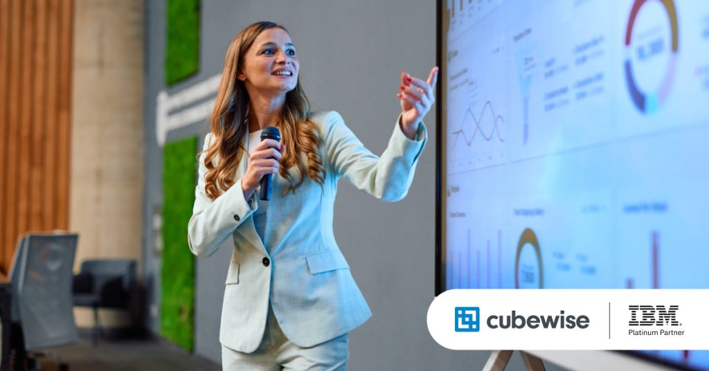 Main: A speaker points to a planning analytics dashboard while giving a presentation at a conference. Inset: Main: An employee gives a data and planning analytics presentation. Inset: Cubewise and Planning Analytics logos.