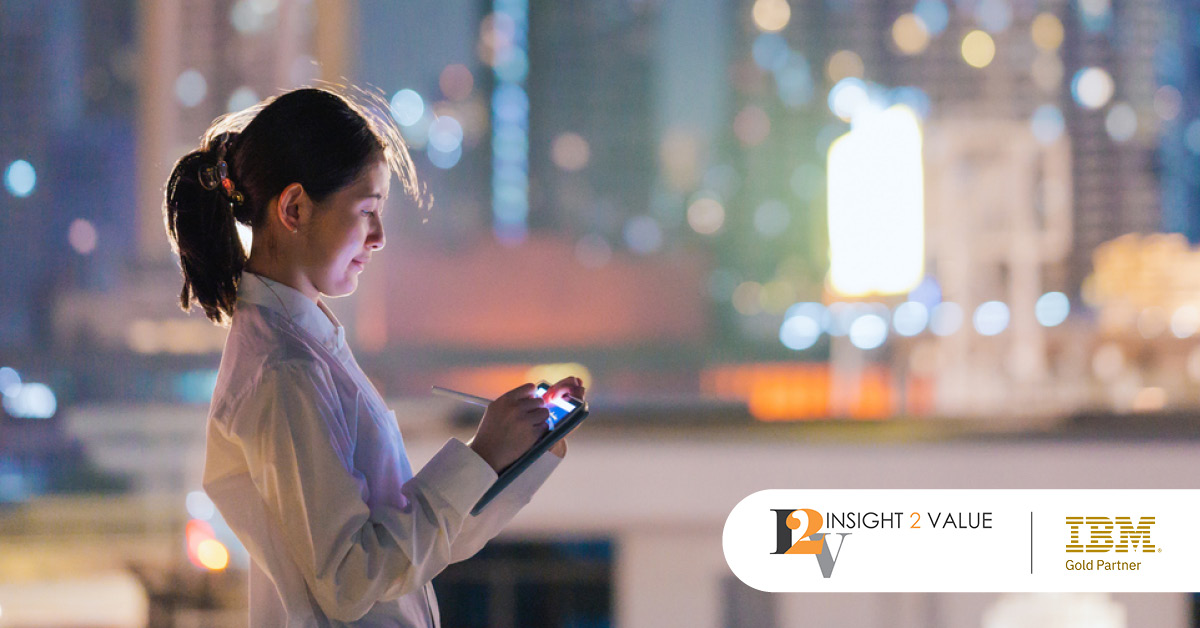 Main: An employee looks at metrics on her portable screen in front of a backdrop of skyscrapers. Inset: Insight 2 Value and IBM Gold Partner logos.