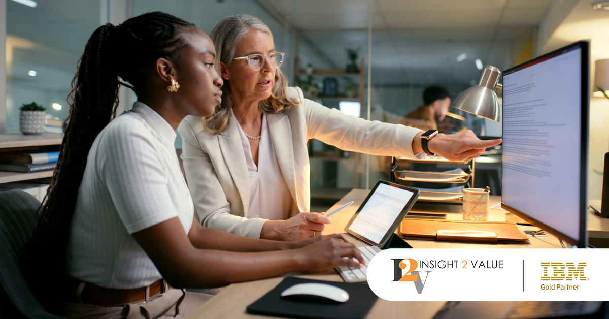 Main: Two employees work together at a computer. Inset: Insight 2 Value and IBM Gold Partner logos.