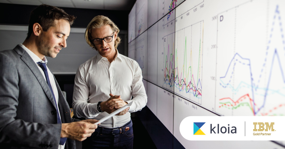Main: Two employees analyse results from a digital dashboard. Inset: Kloia and IBM Gold Partner logos.