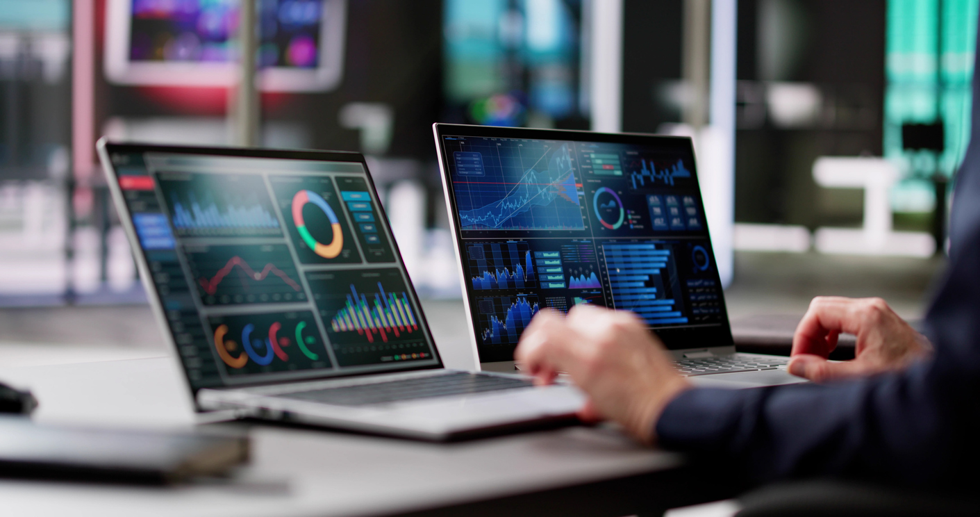 Program monitoring with dashboard analytics on two laptops