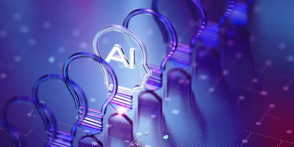A series of lightbulbs, with one mimicking a human head lit up by the letters 'AI' inside it.